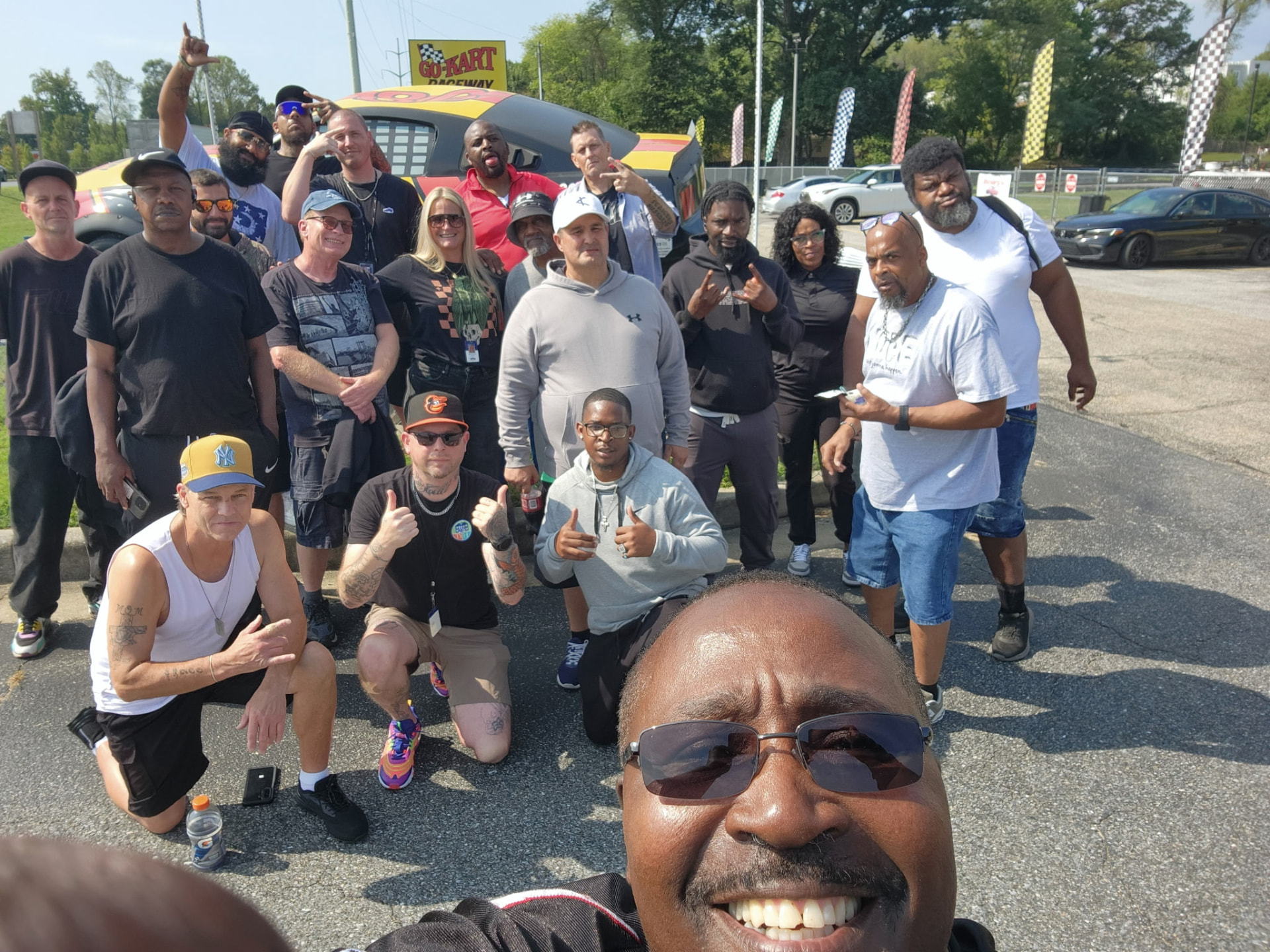 Community members smiling together during an outdoor group activity